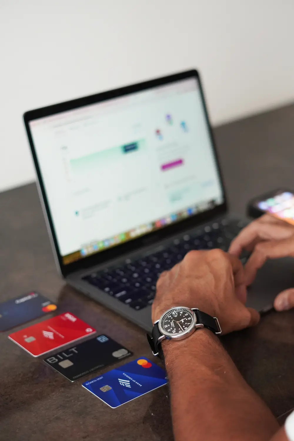 Business owner organizing company financial documentation on a laptop