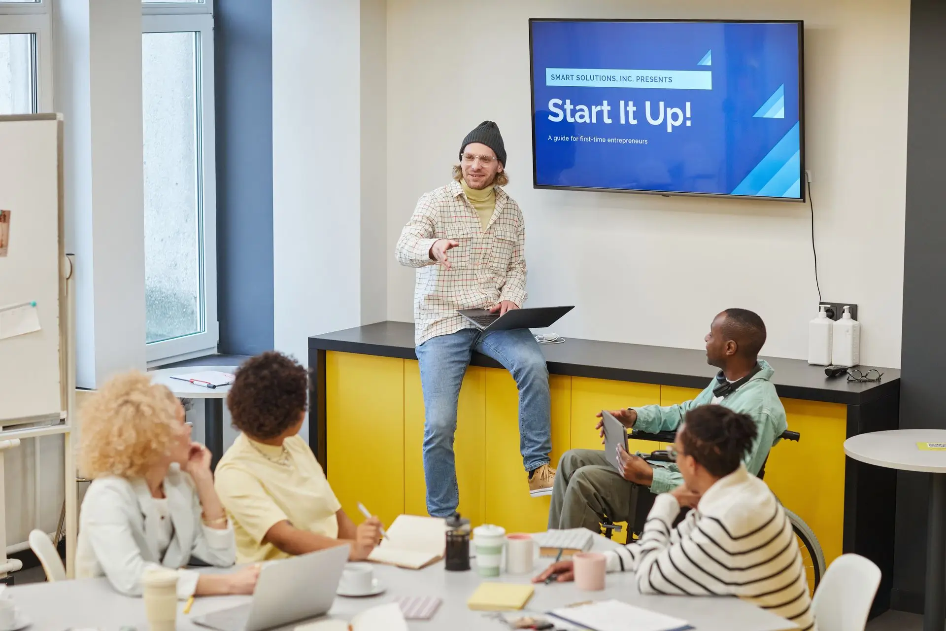 Business Management Consulting | Valyon Business consultant presenting a management strategy to a small team